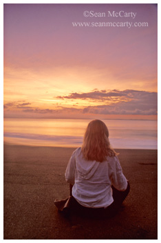 Woman on the beach at sunrise, Puerto Jimenez, Costa Rica